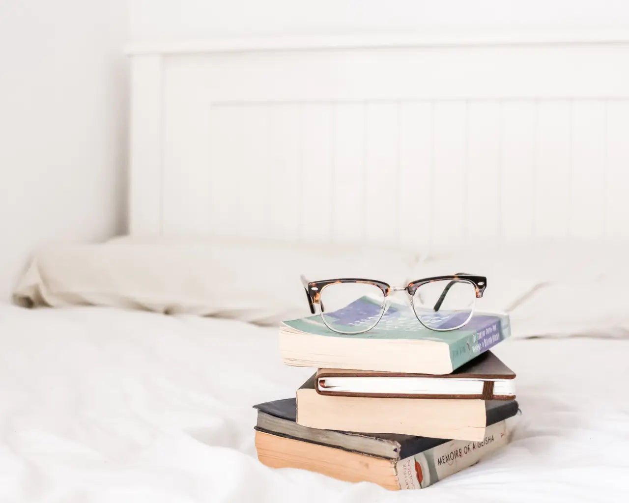 Glasses sitting on books from The Optical Co
