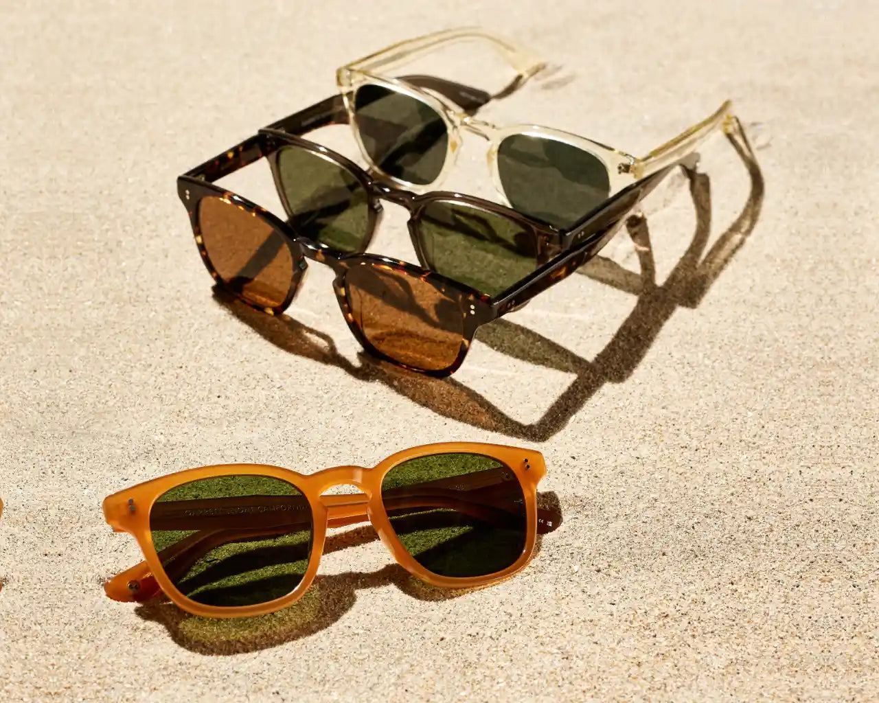 Ace II sunglasses collection on the sand of a beach. Image by GLCo