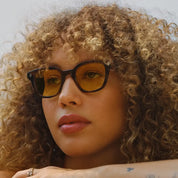 Model wearing custom GLCO Naples glasses with custom yellow tinted lenses