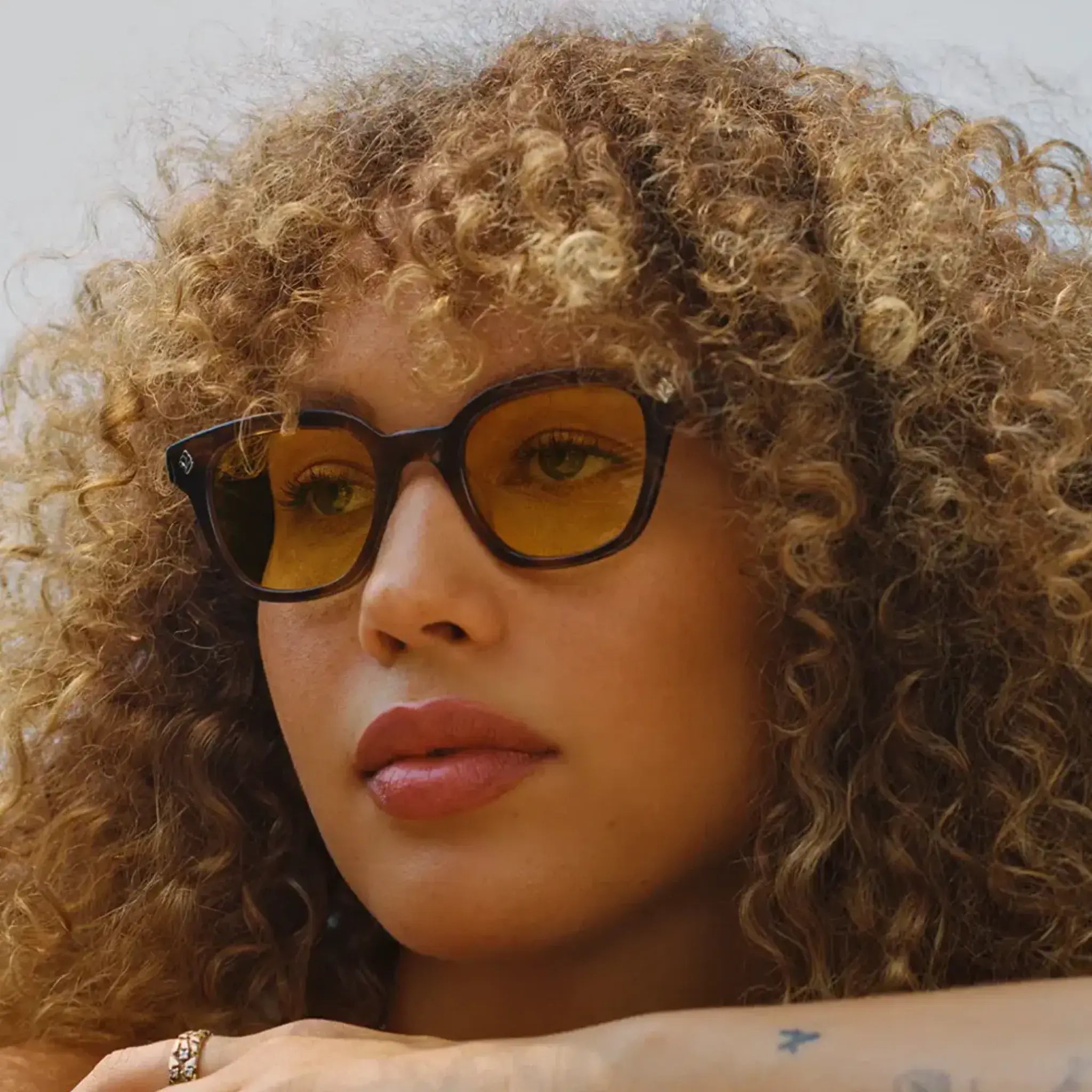 Model wearing custom GLCO Naples glasses with custom yellow tinted lenses
