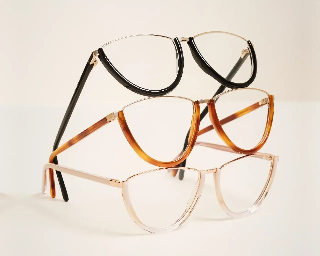 Andy Wolf luxury eyeglasses stacked on top of each other