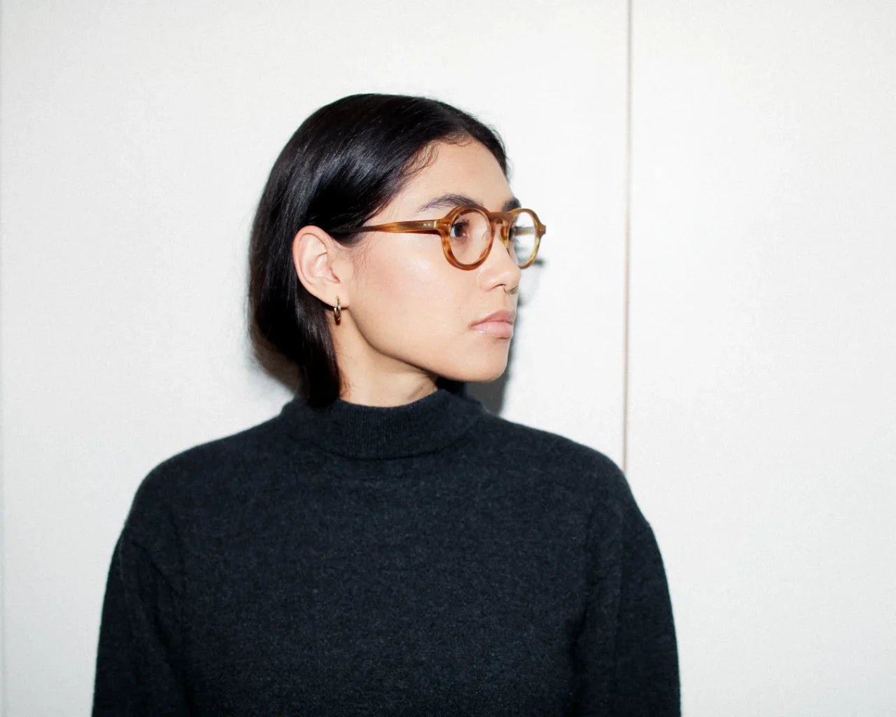 Model wearing round eyeglasses. Image credit: Article One