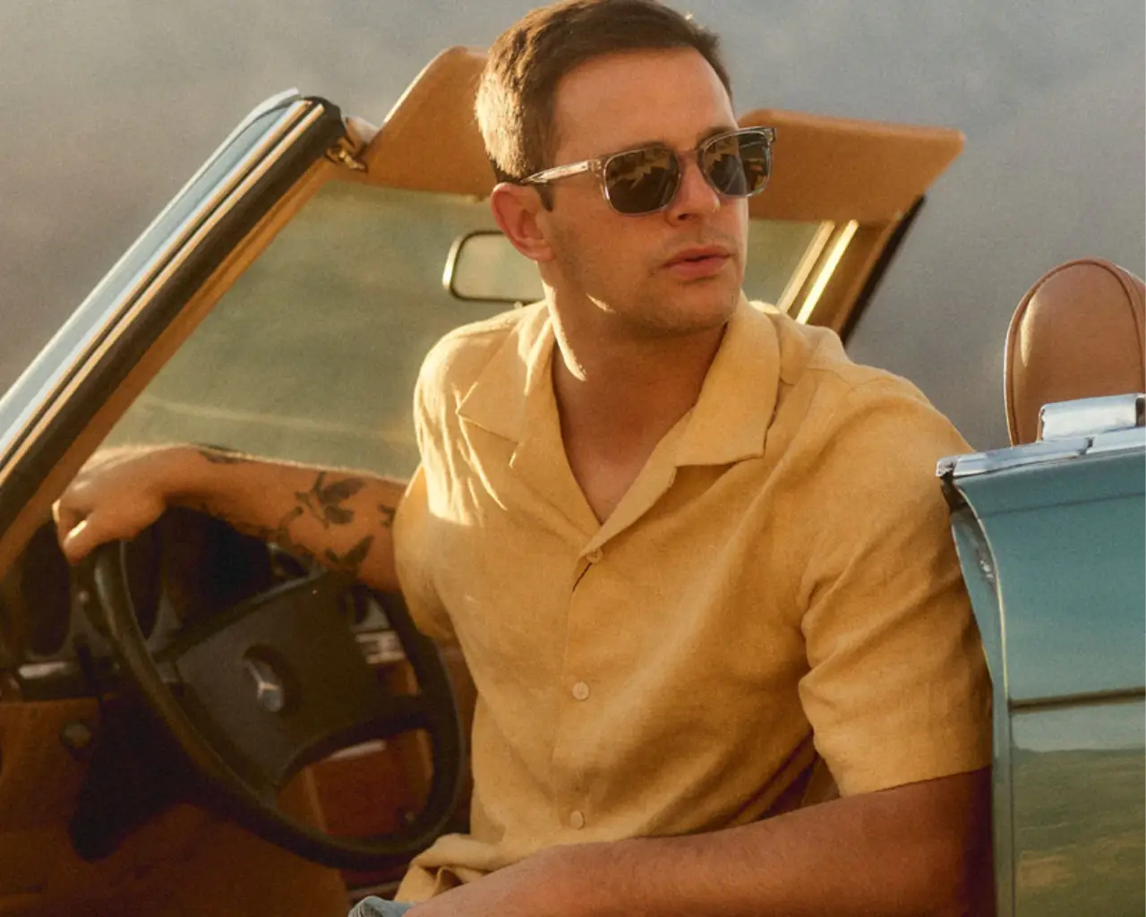 Man in vintage car wearing SALT. Pacific Sunglasses available at The Optical. Co. Image credit: SALT.