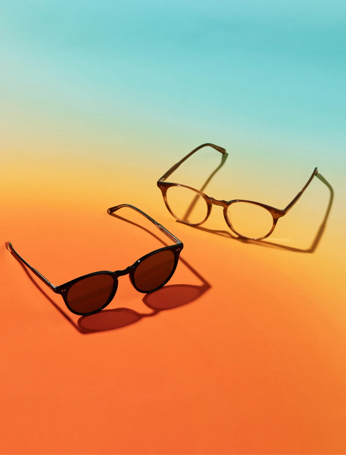 Two pairs of sunglasses on a gradient background. Image credit: GLCO