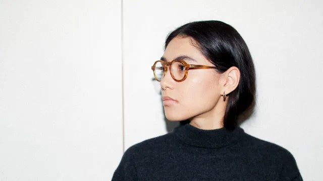 Model wearing small round eyeglass frames from Article One