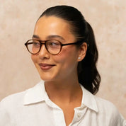 Model wearing Garrett Leight aviator round eyeglass frames 