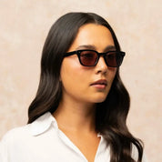 Model wearing Black narrow rectangular plastic wayfarer sunglasses by GLCO and white shirt
