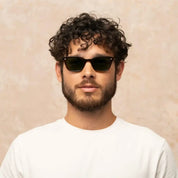 Model wearing narrow rectangular plastic wayfarer sunglasses by GLCO