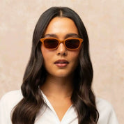 Model wearing Orange Chaparral cat-eyed plastic sunglasses for women by GLCO