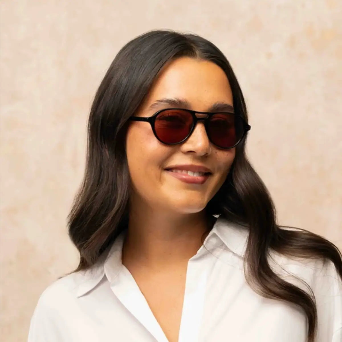 Model wearing black Garrett Leight plastic aviator sunglasses and white shirt