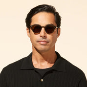 Model wearing green luxury Mr. Leight sunglasses with polarized glass lenses
