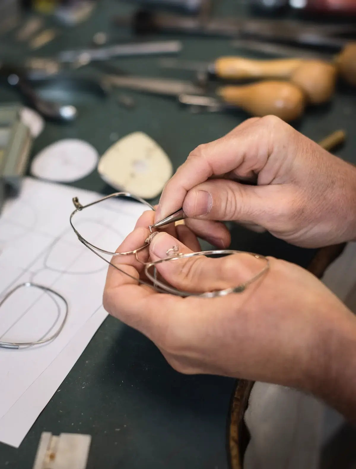 Local master optician custom making metal eyeglass frames