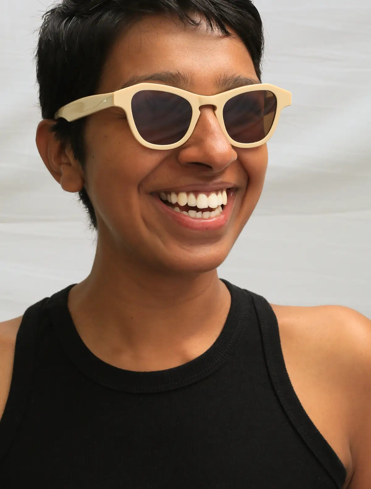 Happy woman wearing Article One sunglasses